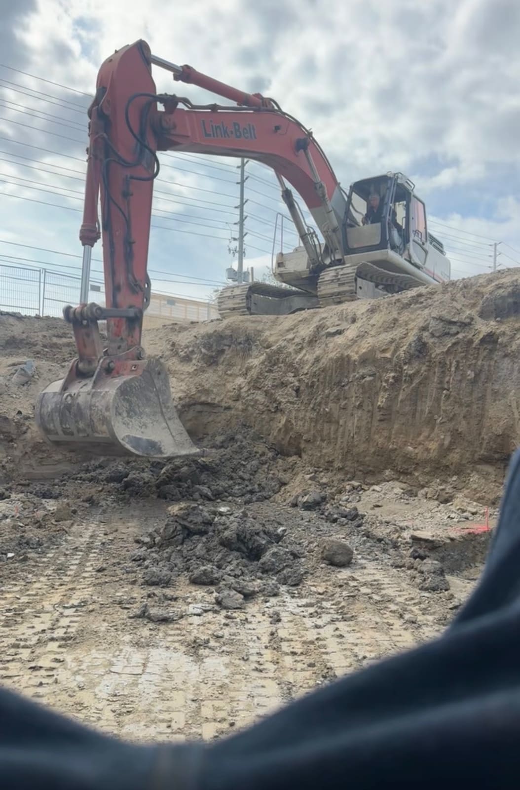 Excavator breaking rock