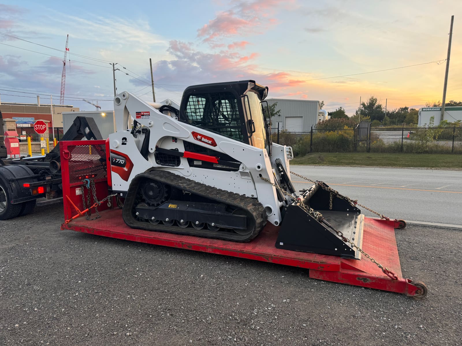 Skid steer loaded at sunset