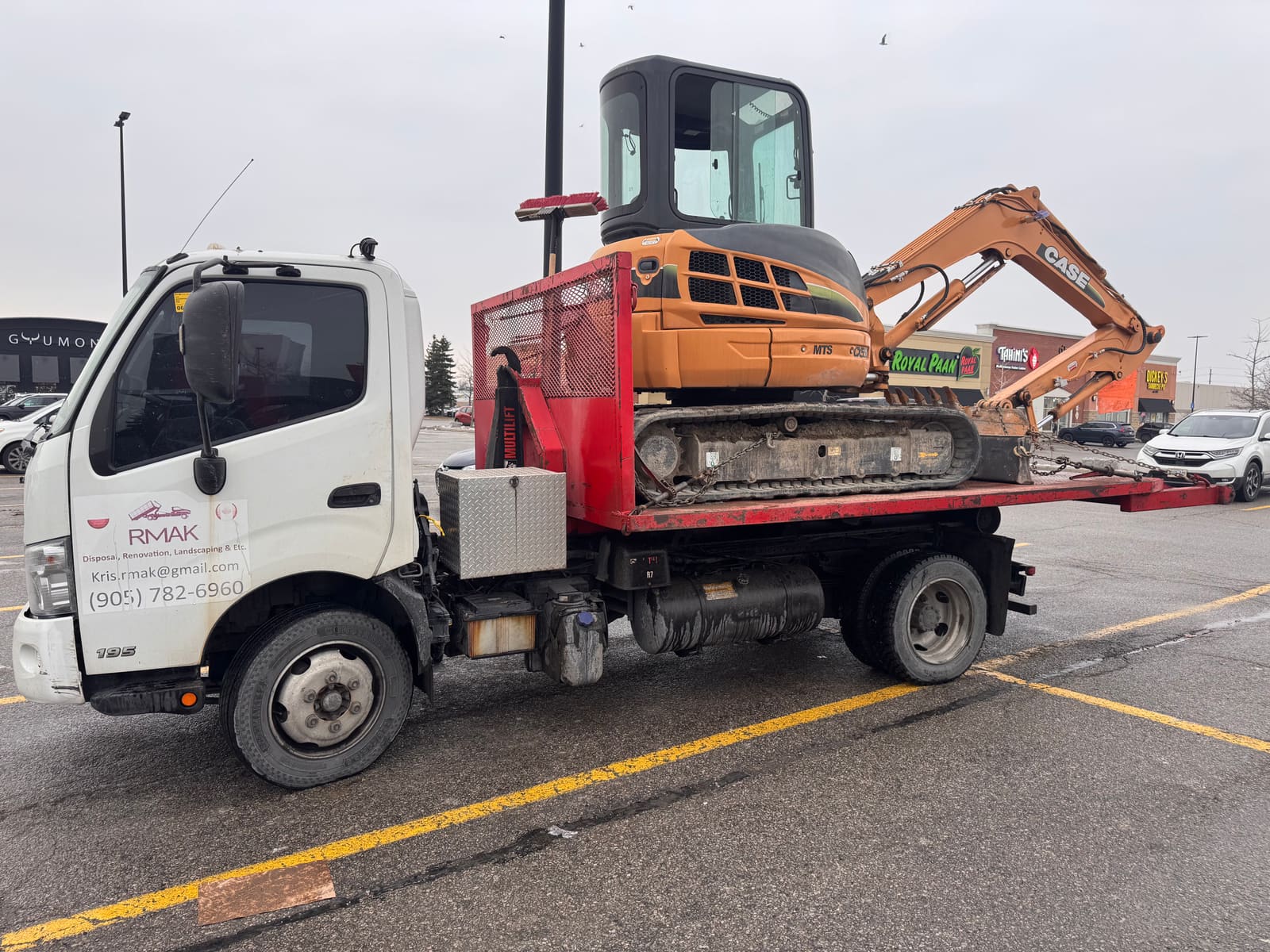 RMAK truck hauling an excavator